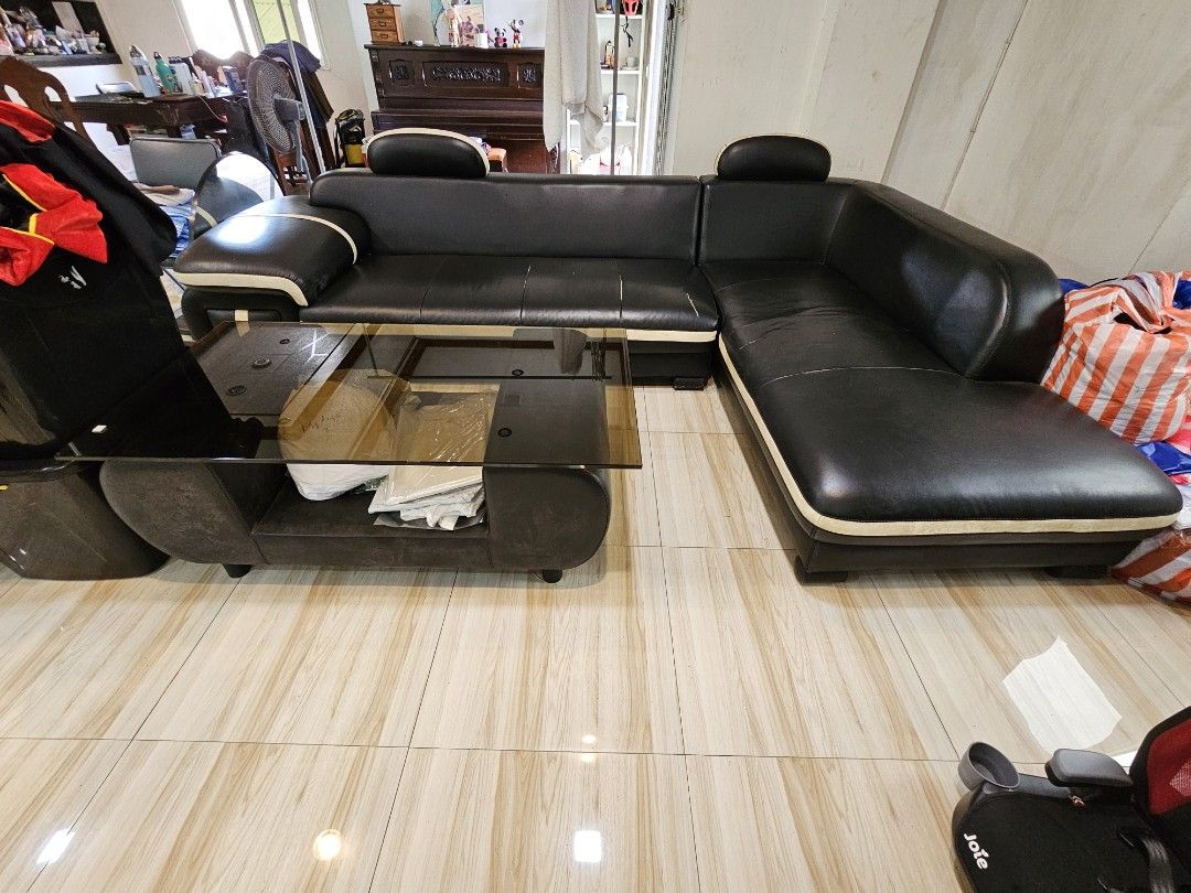 Black Leather Sectional Sofa with Coffee Table (Category: Sofas) located in Navotas City. Submitted by ryantim23 (Listing ID 1411501251, Image 3). Description: Stylish black leather sectional sofa with a matching coffee table. Features a modern design with cream-colored accents. The sofa offers ample seating space and a comfortable design. Includes a coffee table with a glass top and a lower shelf for storage. Perfect for living rooms or lounges.