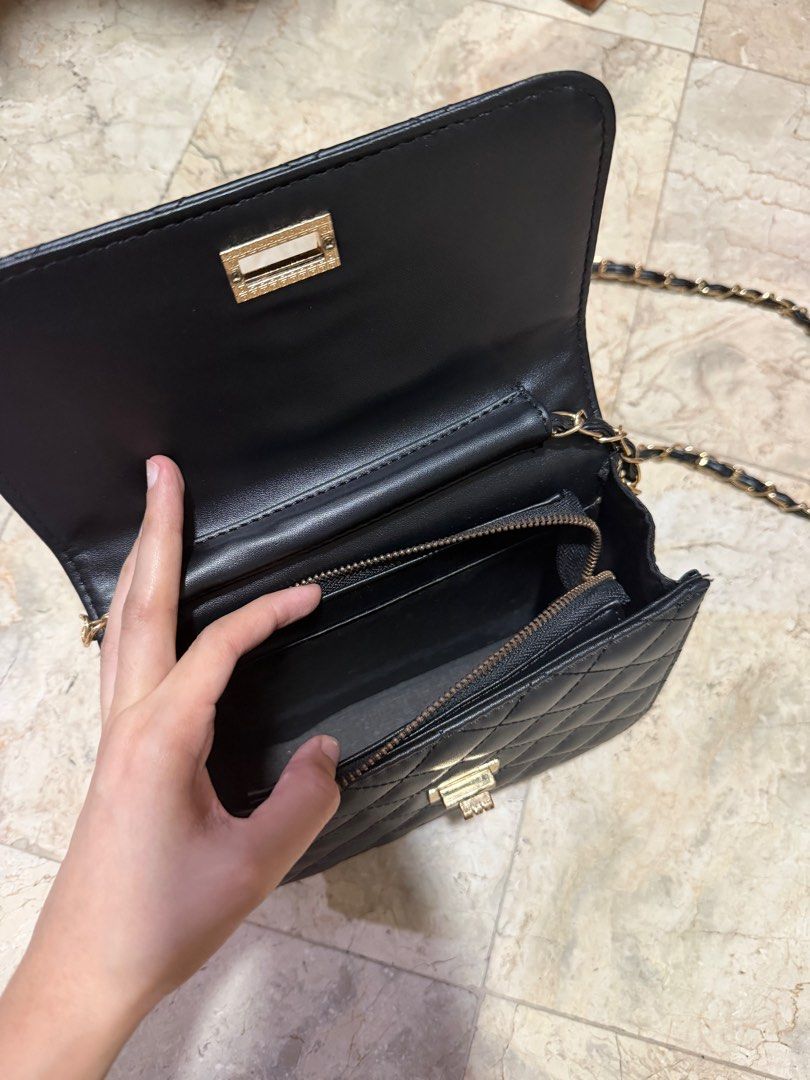 Black Quilted Crossbody Bag with Chain Strap (Category: Cross-body Bags) located in Manila. Submitted by nikkimozarella (Listing ID 1411504511, Image 3). Description: - Black quilted crossbody bag - Gold-tone chain strap - Gold-tone clasp closure - Interior zippered pocket - Back pocket - with minimal flaw on bag lock (see last photo).