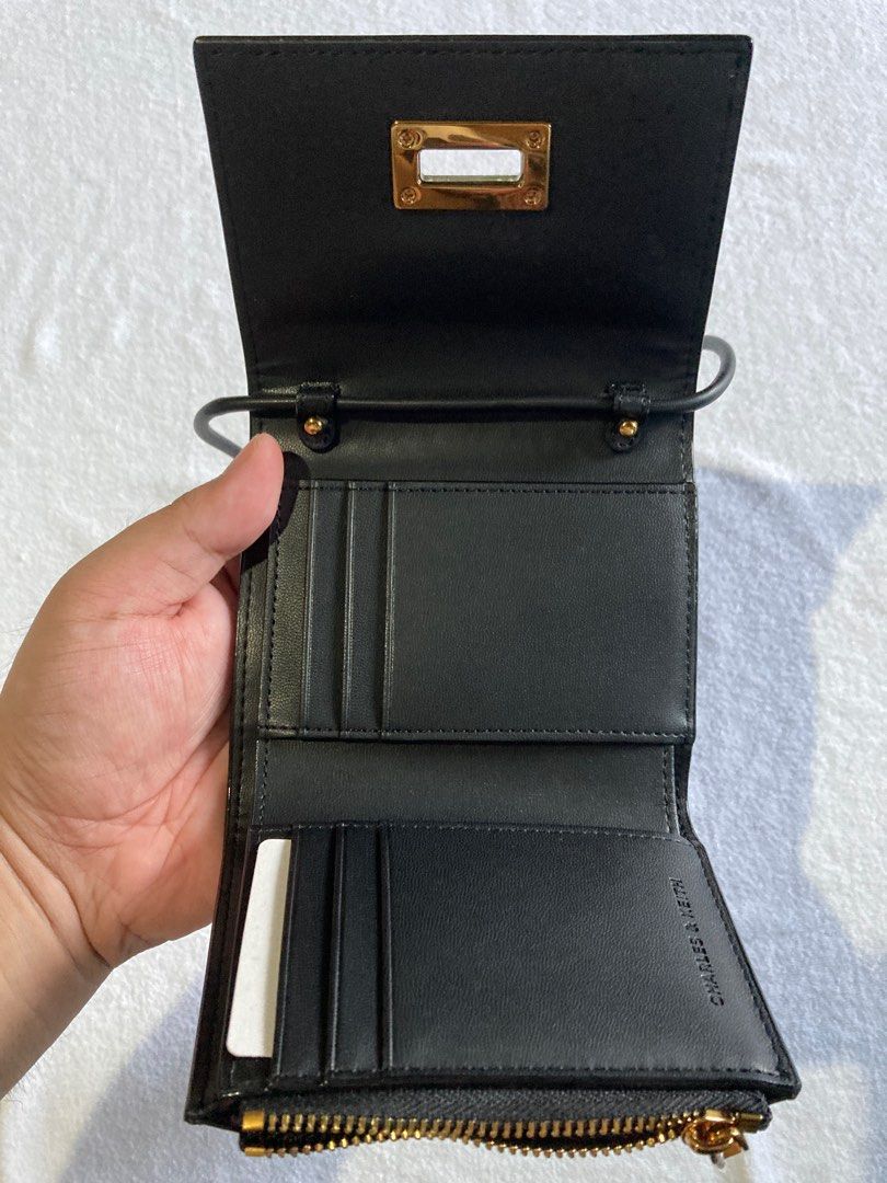 Charles & Keith - Edna Turn Lock Knotted Strap Wallet (Black) (Category: Wallets & Card holders) located in Bogo. Submitted by jantend (Listing ID 1411541258, Image 3). Description: 👜 Charles & Keith 2-in-1 Edna Turn-Lock Wallet & Mini Crossbody - Classic Black Elegance meets versatility. A chic accessory for day or night. ✨ Design & Features • Dual Style: Detachable strap converts wallet to mini crossbody • Premium Gold-Tone Turn-Lock: Luxury a