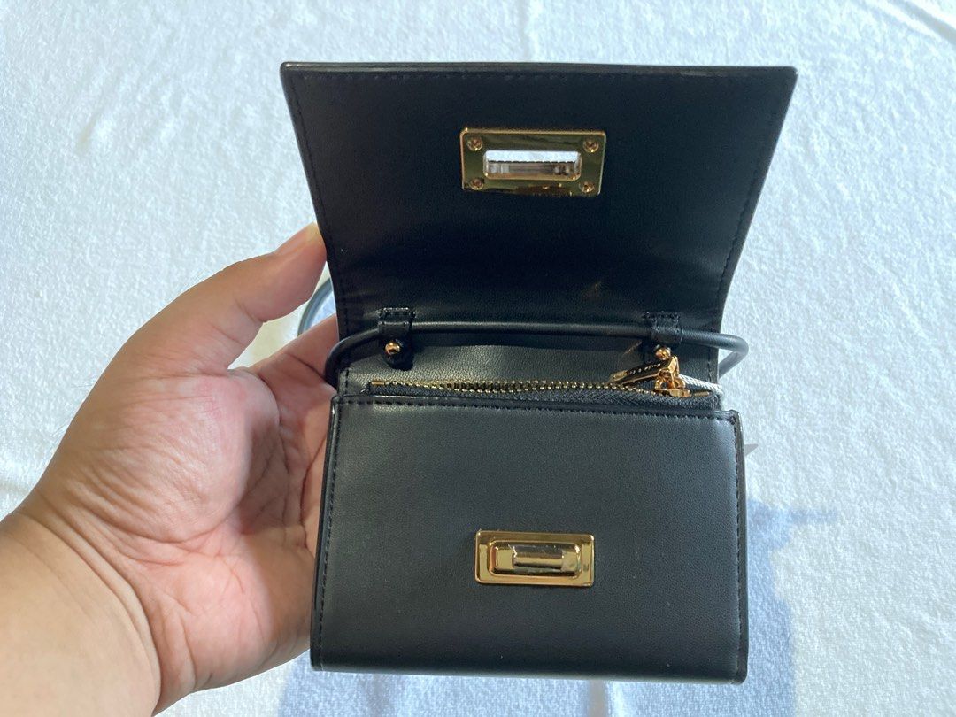 Charles & Keith - Edna Turn Lock Knotted Strap Wallet (Black) (Category: Wallets & Card holders) located in Bogo. Submitted by jantend (Listing ID 1411541258, Image 2). Description: 👜 Charles & Keith 2-in-1 Edna Turn-Lock Wallet & Mini Crossbody - Classic Black Elegance meets versatility. A chic accessory for day or night. ✨ Design & Features • Dual Style: Detachable strap converts wallet to mini crossbody • Premium Gold-Tone Turn-Lock: Luxury a