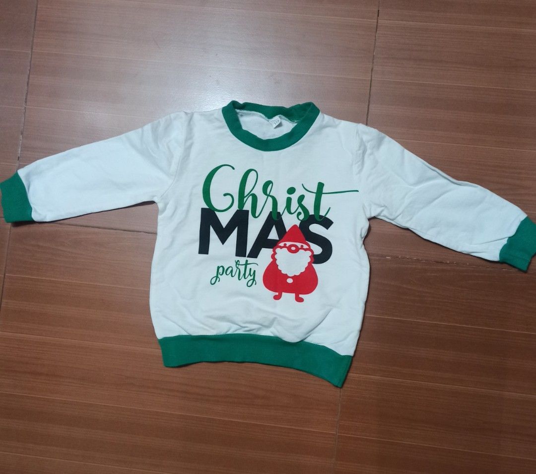 Christmas Party Sweater ( 3-4 yrs old) (Category: Babies & Kids Fashion) located in Las Pinas. Submitted by ejstyles (Listing ID 1411459713, Image 3). Description: - White long-sleeved sweater - Green collar and cuffs - Features "ChristMAS party" text - Santa Claus graphic on front - Used only once.