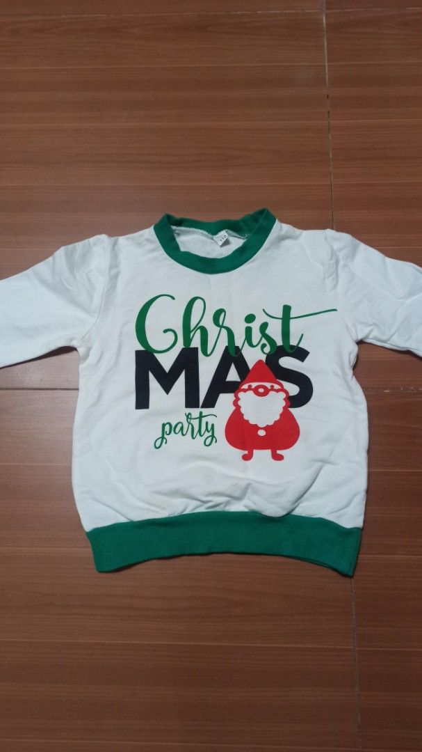 Christmas Party Sweater ( 3-4 yrs old) (Category: Babies & Kids Fashion) located in Las Pinas. Submitted by ejstyles (Listing ID 1411459713, Image 2). Description: - White long-sleeved sweater - Green collar and cuffs - Features "ChristMAS party" text - Santa Claus graphic on front - Used only once.