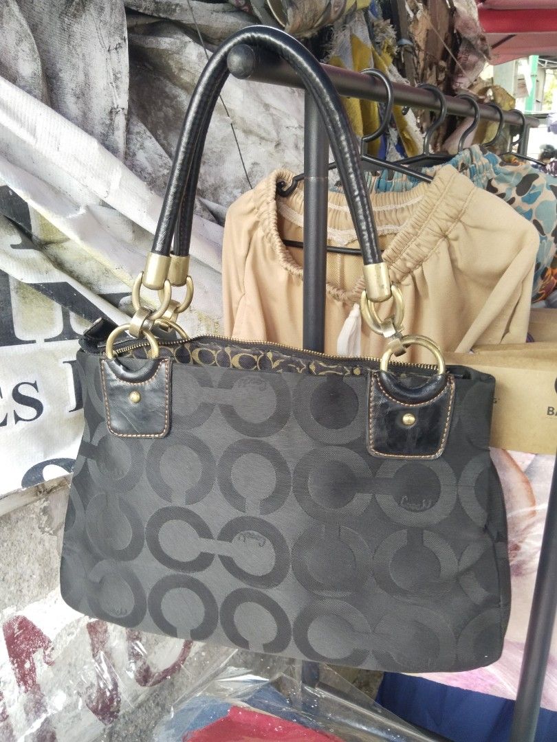 Coach Black Signature Handbag (Category: Luxury Bags & Wallets) located in Paranaque City. Submitted by jayson193 (Listing ID 1411515715, Image 2). Description: - Authentic Coach handbag - Black with signature pattern - Gold-tone hardware - Front pocket - Zip closure - Patterned interior lining - Dual handles - Includes Coach tag.