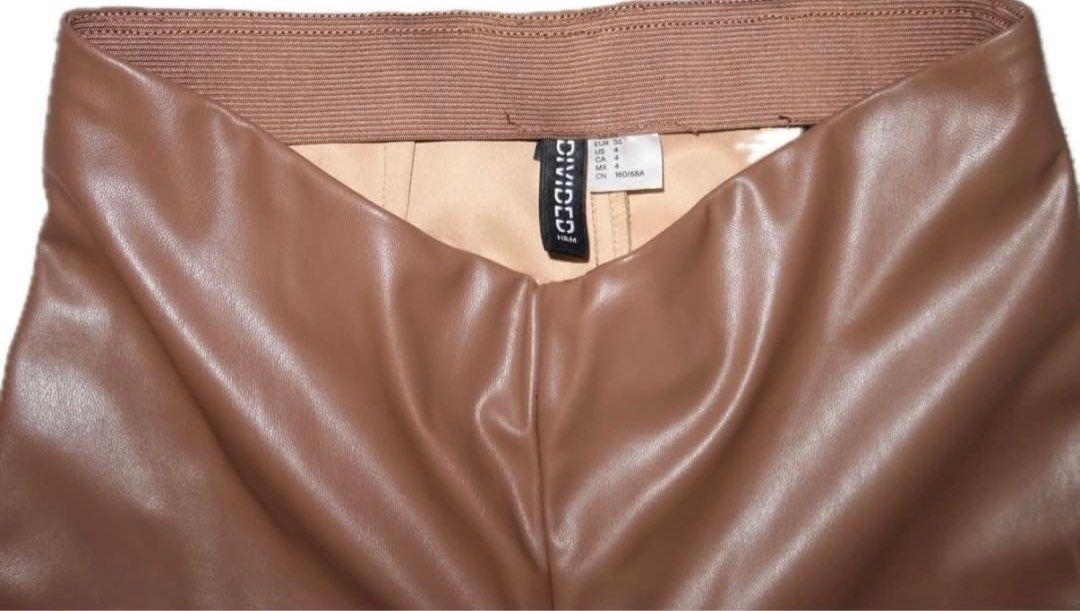 H&M Divided Faux Leather Pants (Category: Jeans) located in Bulacan. Submitted by eggydibs (Listing ID 1411471325, Image 3). Description: - H&M Divided faux leather pants - Color: Brown - Size: 4 - Style: High-waisted, flared - Features: Split hem - Material: Smooth faux leather.