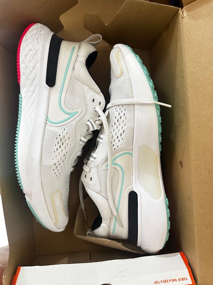 Nike Men’s Running Shoes (Category: Sneakers) located in Manila. Submitted by jaydeclutter (Listing ID 1411565515, Image 3). Description: - White Nike running shoes - Black and teal accents - Breathable mesh upper - Cushioned sole - Lace-up closure - Nike swoosh logo - Teal insole with Nike logo - Includes original box.