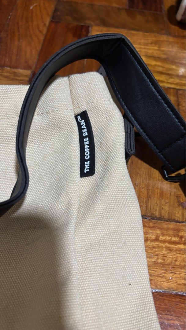 The Coffee Bean & Tea Leaf Unisex Multi-way Bag (Category: Tote Bags) located in Manila. Submitted by gingercat1111 (Listing ID 1411452892, Image 2). Description: - The Coffee Bean & Tea Leaf tote bag. - Beige canvas exterior. - Black straps. - Front pocket with brand logo. - Includes both shoulder straps and handles. - Interior with multiple pockets for organization..