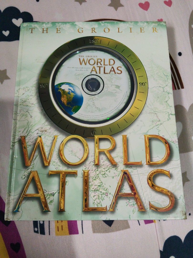 The Grolier World Atlas (Category: Textbooks) located in Manila. Submitted by betsybanayos (Listing ID 1411496584, Image 1). Description: - Grolier World Atlas with CD-ROM - Features a detailed world map - Gold lettering on the cover - Includes a CD-ROM with extra content - Ideal for educational use and geography enthusiasts.