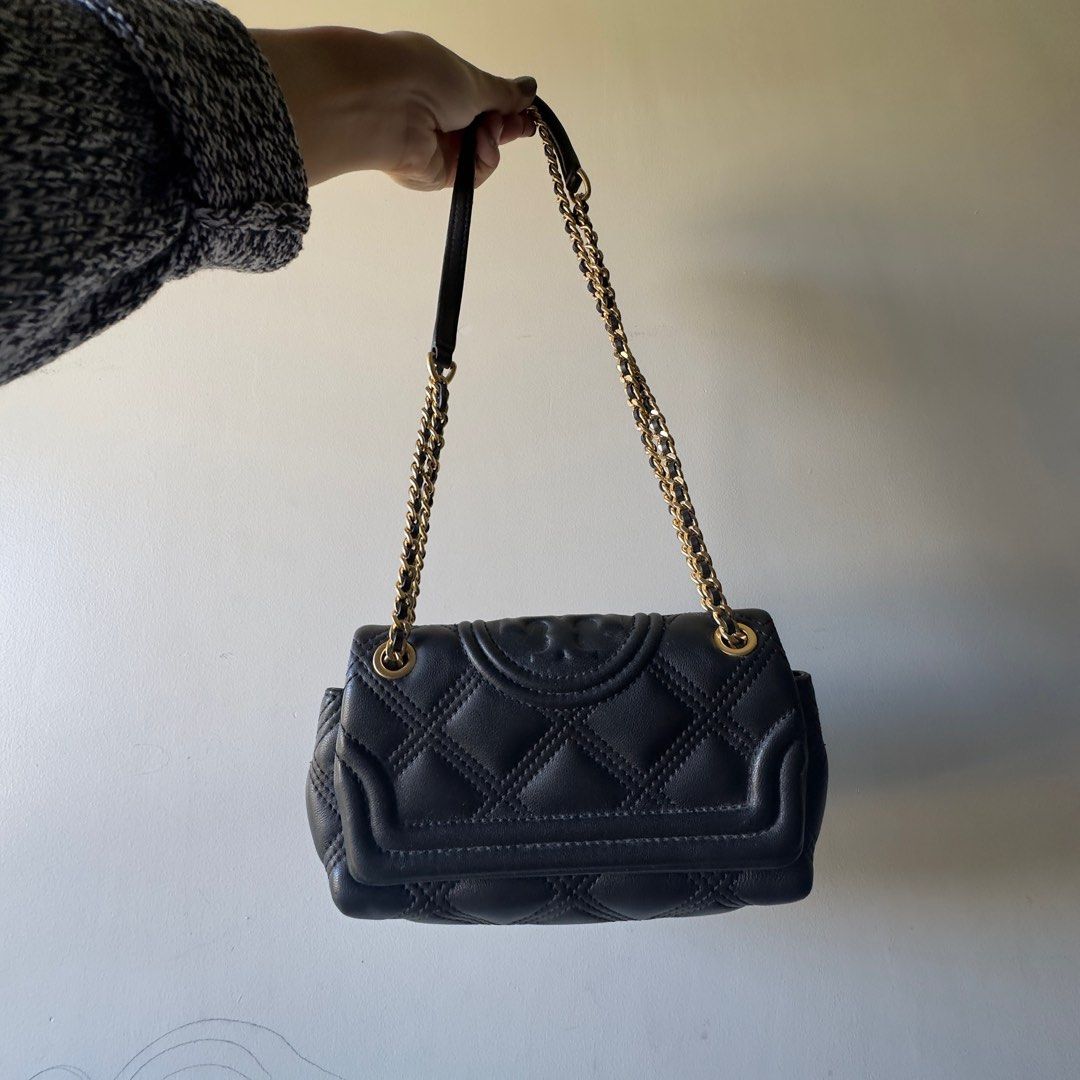 Tory Burch Fleming Small Convertible Shoulder Bag (Category: Luxury Bags & Wallets) located in Baguio. Submitted by emarielai (Listing ID 1411492612, Image 2). Description: - Tory Burch shoulder bag - Black quilted leather - Gold-tone chain strap - Features Tory Burch logo - Diamond-stitched pattern - Can be worn as shoulder bag or crossbody Bought for 15k selling for 8k with dust bag.