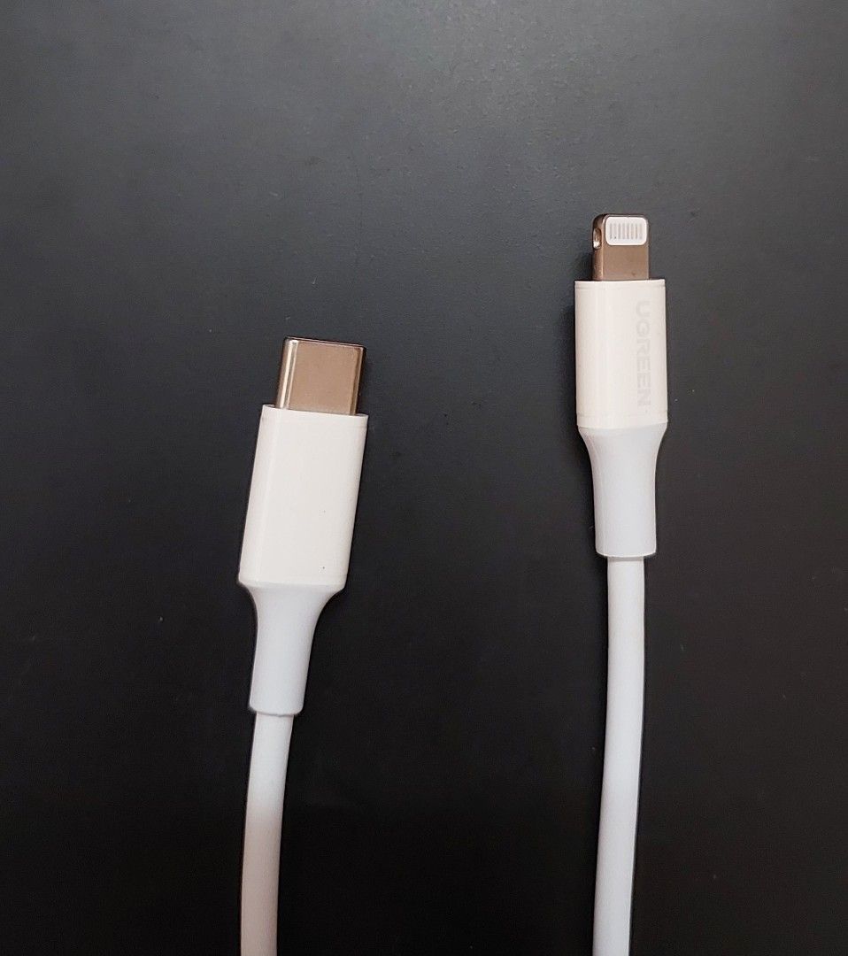 Ugreen Apple Charger Cord USB-C/Type C to Lightning (Category: Chargers & Cables) located in Manila. Submitted by tj.ong28 (Listing ID 1411453405, Image 2). Description: - Ugreen USB-C to Lightning Cable - Original - Compatible with iPhone, iPad, and iPod - Fast charging - White color MOP: Gcash/Bank Transfer MOD: Lalamove/JNT.