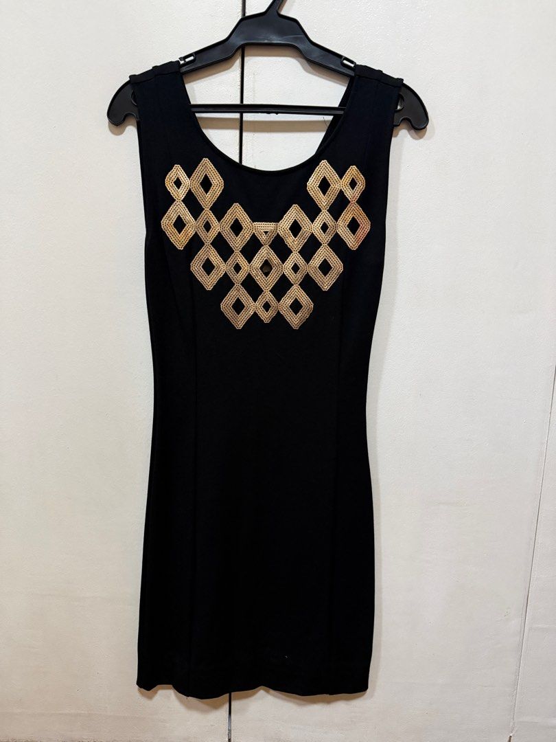 Black Sleeveless Dress (Category: Dresses) located in Manila. Submitted by coolforesty-80 (Listing ID 1411755688, Image 1). Description: - Black sleeveless dress - Scoop neckline - Fitted silhouette - Gold geometric embellishments on bodice - Knee-length .