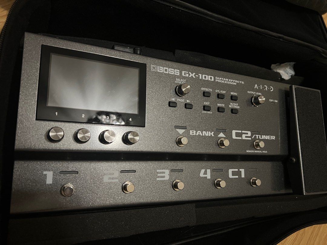 Boss GX-100 Guitar Effects Processor (Category: Musical Instruments) located in Pasig City. Submitted by teachertin13250 (Listing ID 1411653057, Image 2). Description: - Boss GX-100 guitar effects processor - Features: - Display screen - Multiple footswitches - Control knobs - Expression pedal - Includes protective case - Model name and brand clearly visible.