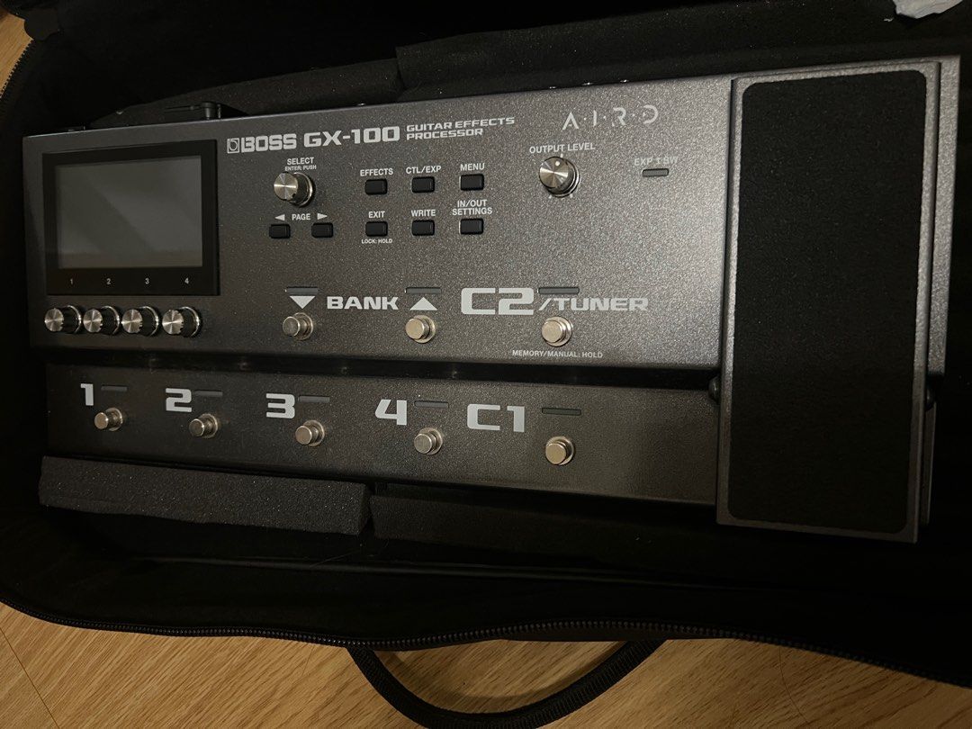 Boss GX-100 Guitar Effects Processor (Category: Musical Instruments) located in Pasig City. Submitted by teachertin13250 (Listing ID 1411653057, Image 1). Description: - Boss GX-100 guitar effects processor - Features: - Display screen - Multiple footswitches - Control knobs - Expression pedal - Includes protective case - Model name and brand clearly visible.