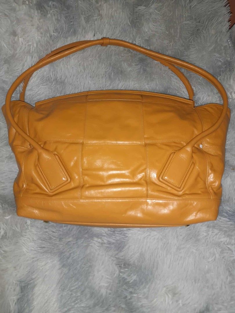 Bottega Veneta Leather Handbag (Category: Luxury Bags & Wallets) located in Zamboanga. Submitted by swiftfish-082e (Listing ID 1411705254, Image 2). Description: - Bottega Veneta handbag - Stunning mustard yellow color - Spacious interior with multiple compartments - Secure zippered closure - Elegant double handles - Distinctive design - Made in Italy - Includes interior pocket - Features "Originality Certified" tag.