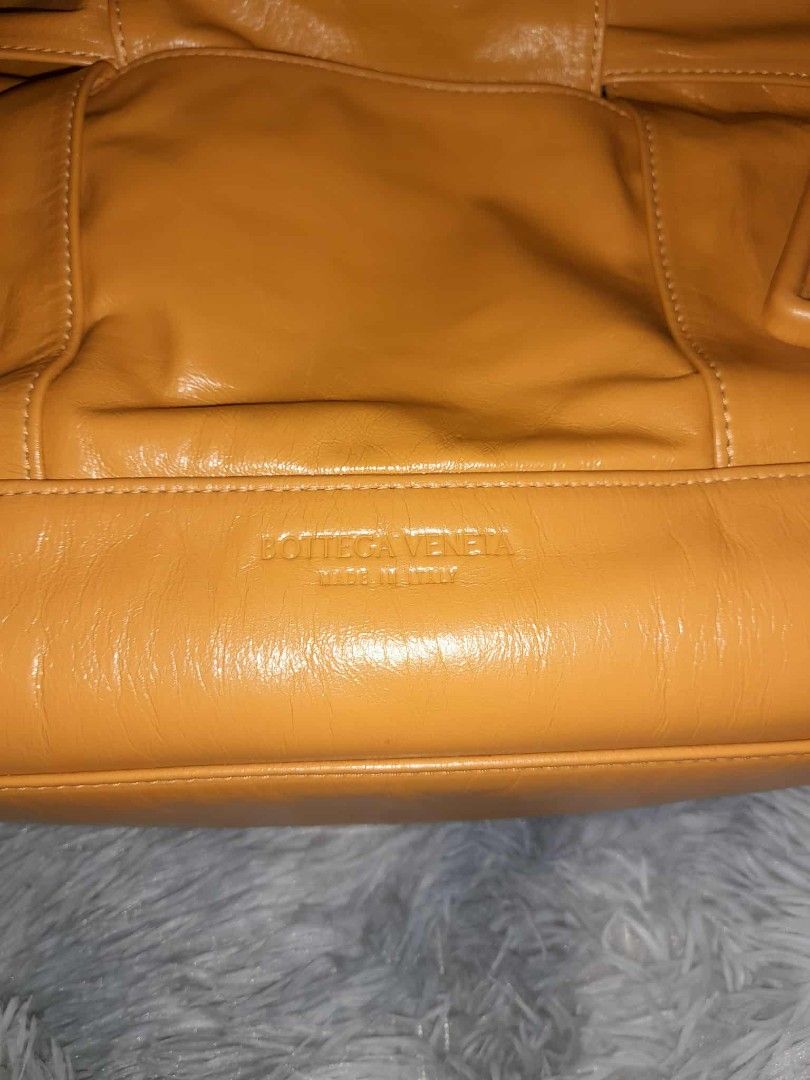 Bottega Veneta Leather Handbag (Category: Luxury Bags & Wallets) located in Zamboanga. Submitted by swiftfish-082e (Listing ID 1411705254, Image 3). Description: - Bottega Veneta handbag - Stunning mustard yellow color - Spacious interior with multiple compartments - Secure zippered closure - Elegant double handles - Distinctive design - Made in Italy - Includes interior pocket - Features "Originality Certified" tag.