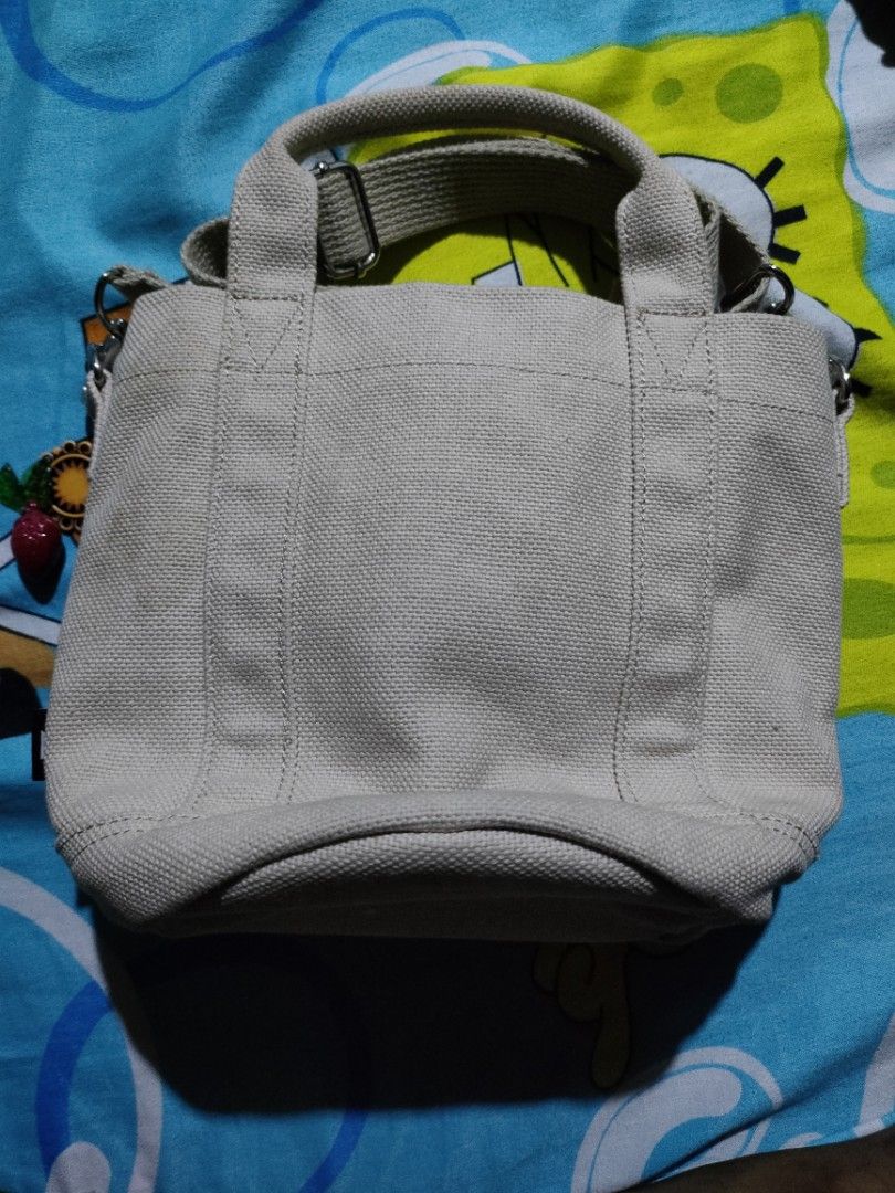 BTS X Fila Bucket Bag (Category: Cross-body Bags) located in Quezon City. Submitted by Cassidy (Listing ID 1411748467, Image 3). Description: - BTS Fila bucket bag - Beige canvas material - Drawstring closure - Top handle - Detachable shoulder strap - Interior pocket - BTS and Fila logo on front - Original Price 6000.