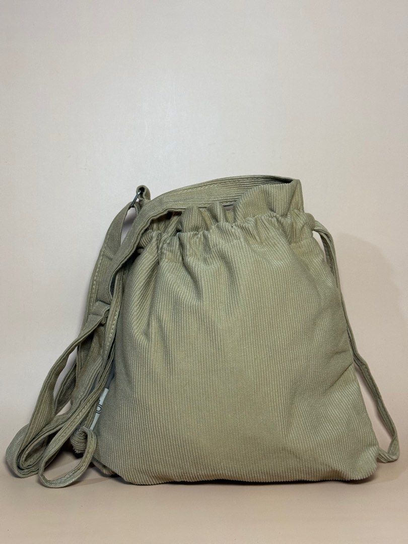 Corduroy Drawstring Bag (Category: Shoulder Bags) located in Pasig City. Submitted by chikaching (Listing ID 1411745010, Image 1). Description: - Corduroy drawstring bag - Main compartment - Adjustable shoulder strap - Neutral color - Versatile for everyday use.