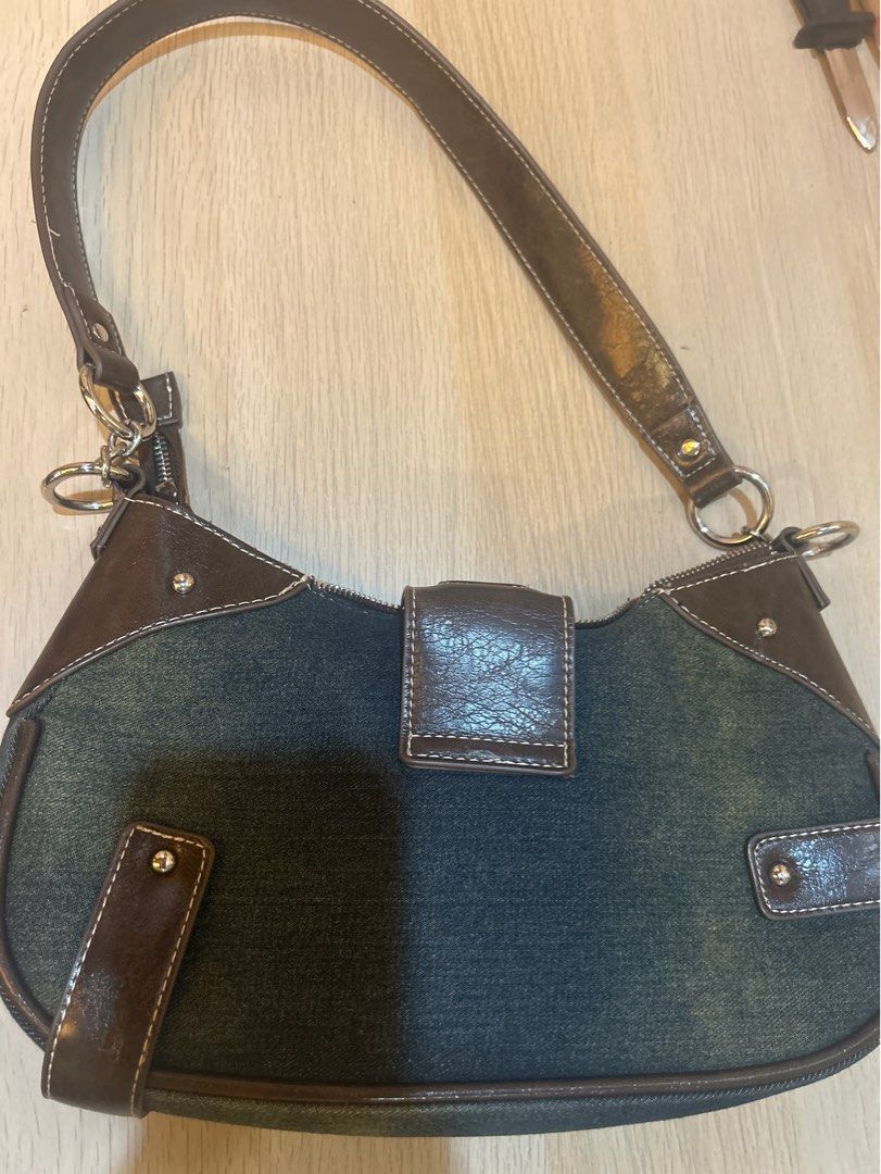 Denim Shoulder Bag Bershka (Category: Shoulder Bags) located in Quezon City. Submitted by darksparklee (Listing ID 1411716123, Image 2). Description: - Denim shoulder bag with brown leather accents - Single shoulder strap - Curved design - Silver-toned hardware - Buckle closure.