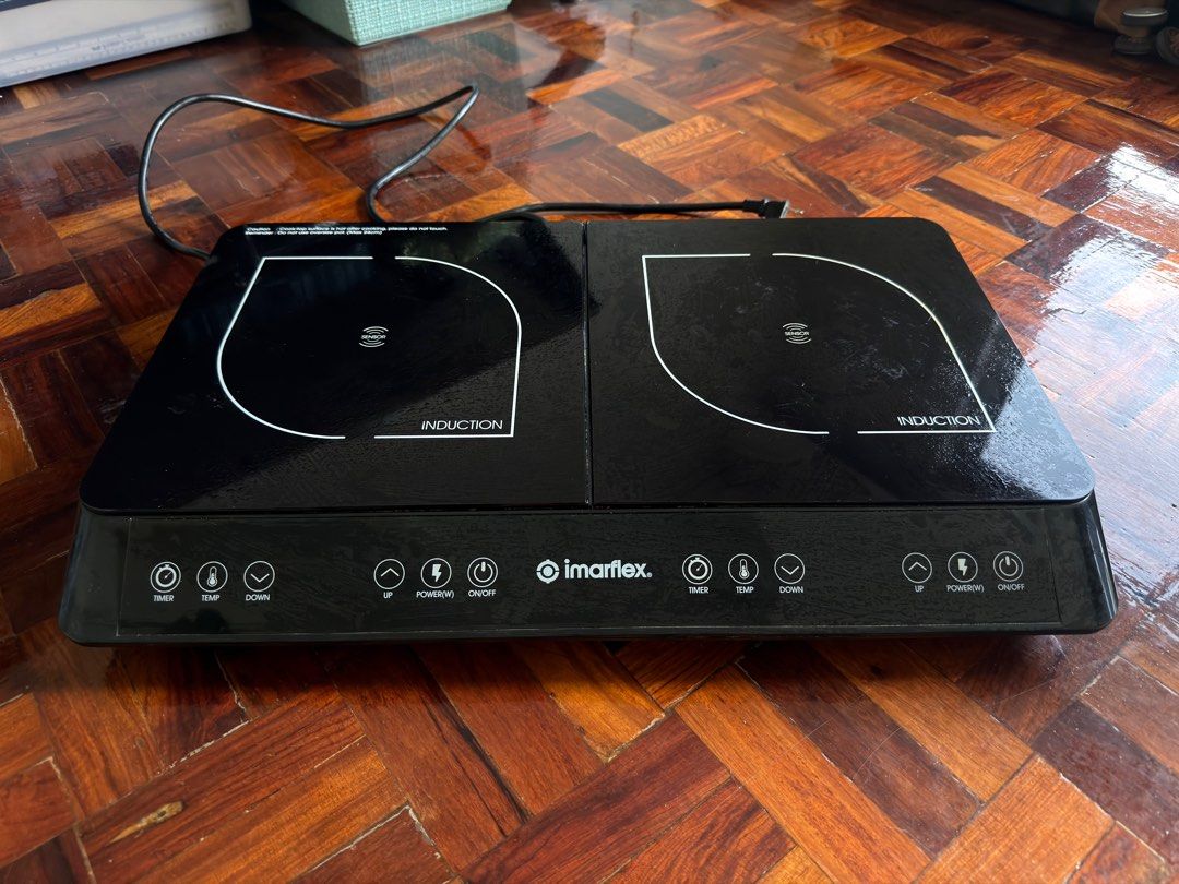 Imarflex Double Induction Cooker (Category: Cookers) located in Quezon City. Submitted by lexieshuu162243 (Listing ID 1411673611, Image 1). Description: - Imarflex double induction cooker - Two cooking zones - Individual temperature and power controls - Timer function - Sleek black surface with white markings - User-friendly control panel Issue: left induction not working.