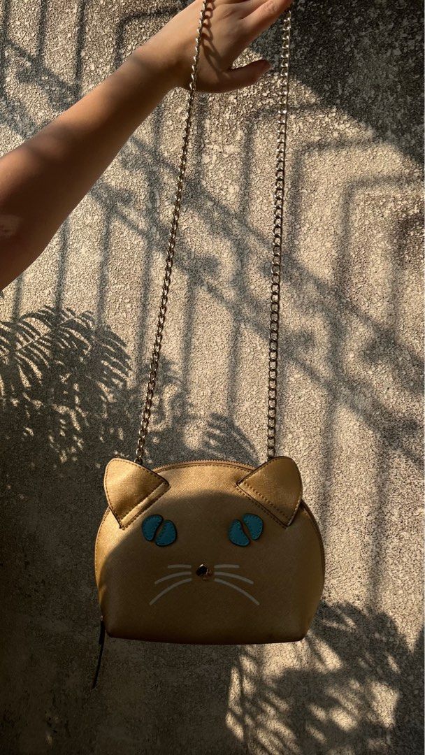 Kate Spade Cat Crossbody Bag (Category: Luxury Bags & Wallets) located in Manila. Submitted by sp734 (Listing ID 1411737033, Image 3). Description: - Kate Spade cat crossbody bag - Unique cat design - Gold-tone chain strap - Zip closure - Interior slip pocket - Gold-tone exterior with cat face details - Retail price: $108.