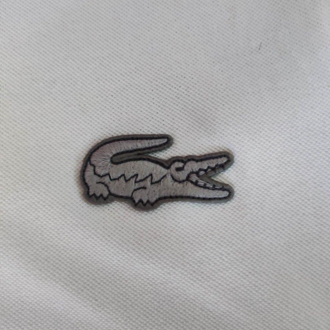 Lacoste Regular Fit Polo Shirt (Category: Tshirts & Polo Shirts ) located in Taguig. Submitted by lawrence_stuff (Listing ID 1411657447, Image 2). Description: - Authentic Lacoste polo shirt - Color: White with grey collar and cuffs - Features the iconic Lacoste crocodile logo - Made in Peru - Size: FR 4 / US M - Material: 100% cotton - Fit: Regular.