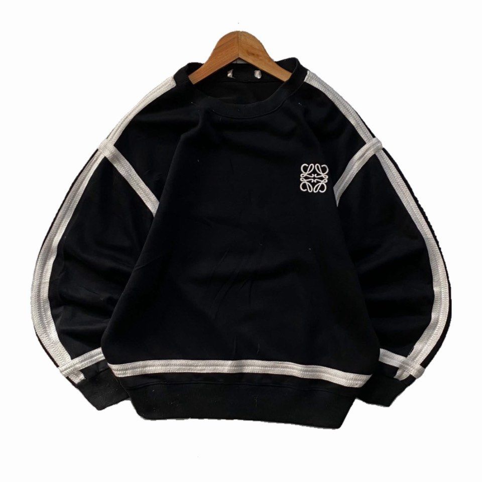 Loewe Black Sweatshirt with White Stripes (Category: Longsleeves) located in Manila. Submitted by ricszsthrift (Listing ID 1411720637, Image 1). Description: - Loewe sweatshirt with embroidered logo - White stripes on sleeves and hem - Crew neck design - Signs of wear and tear: - Faded stripes - Collar wear - Loose stitching in some areas 🌪️LOEWE (LONG SLEEVE) -DIMES: W-22.5 L-25.5 -9.5/10 CONDITION -9.5/10 COLOR RATE -DETAILS IS IN THE COMMENT 