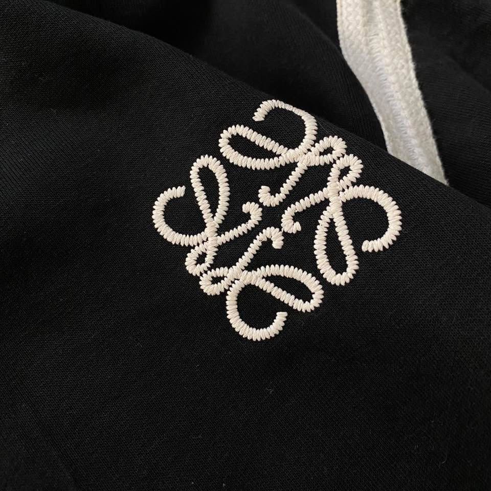 Loewe Black Sweatshirt with White Stripes (Category: Longsleeves) located in Manila. Submitted by ricszsthrift (Listing ID 1411720637, Image 3). Description: - Loewe sweatshirt with embroidered logo - White stripes on sleeves and hem - Crew neck design - Signs of wear and tear: - Faded stripes - Collar wear - Loose stitching in some areas 🌪️LOEWE (LONG SLEEVE) -DIMES: W-22.5 L-25.5 -9.5/10 CONDITION -9.5/10 COLOR RATE -DETAILS IS IN THE COMMENT 