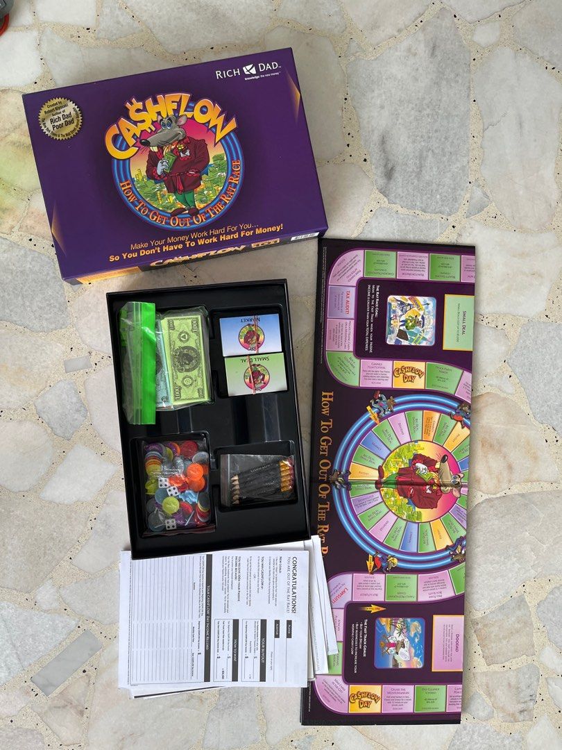 Rich Dad Cashflow Board Game (Category: Board Games & Puzzles) located in Singapore. Submitted by hashb (Listing ID 1411658790, Image 2). Description: - Cashflow board game by Rich Dad - Complete set with all components - Includes game board, cards, play money, and tokens - Great for learning financial literacy and investing.