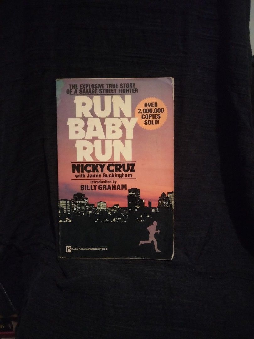 Run Baby Run by Nicky Cruz (Category: Storybooks) located in Manila. Submitted by moranolito25893 (Listing ID 1411777778, Image 1). Description: Book tells the explosive true story of a savage street fighter. It is written by Nicky Cruz with Jamie Buckingham and an introduction by Billy Graham. The book has sold over 2,000,000 copies. The cover features a silhouette of a person running in front of a city skyline..