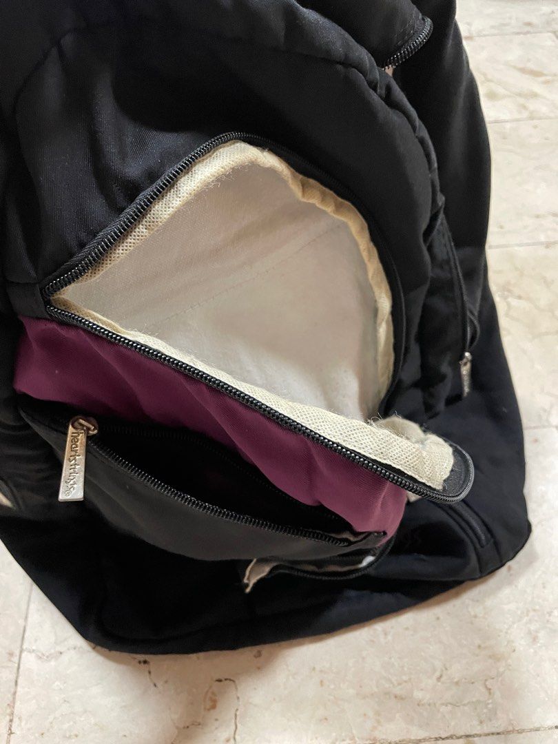 SKO-003 Heartstrings Black Backpack (Category: Backpacks) located in Manila. Submitted by iamspicy (Listing ID 1411645674, Image 2). Description: Buy at least 2 items from me to get discount. Payment first. Shipping fee shouldered by Buyer. No meetups. - Interior shows some stains - Black backpack with purple accent - Features multiple zippered compartments - Front pocket with "heartstrings" logo - Interior zippered pocket - Adjustable straps - P