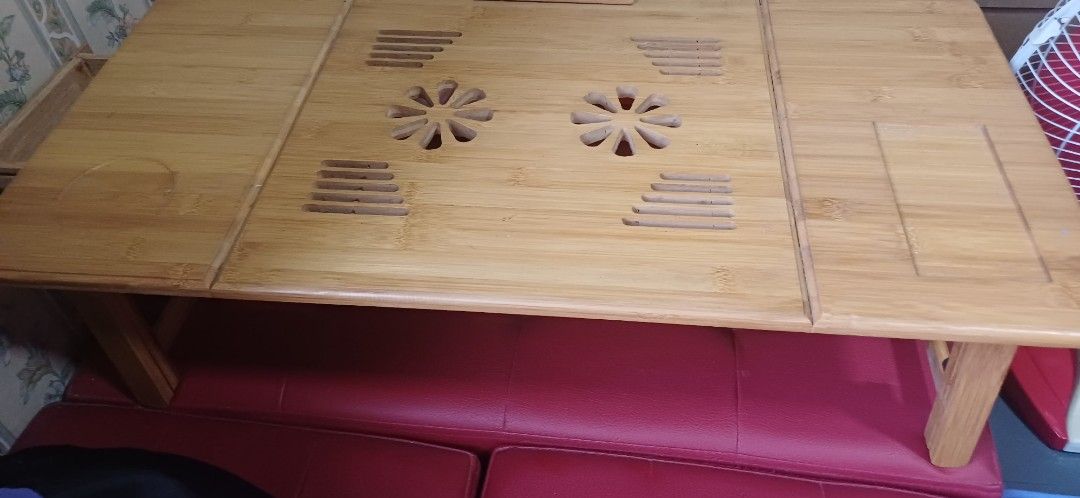 Wooden Foldable Table with Adjustable Legs (Category: Tables & Sets) located in Manila. Submitted by kahlen36985 (Listing ID 1411689430, Image 3). Description: - Foldable bamboo laptop table - Adjustable height for the legs and adjustable angle for the laptop or tablet - Features ventilation holes to prevent overheating - Includes a small drawer for storage - Perfect for working or studying in bed or on the couch.