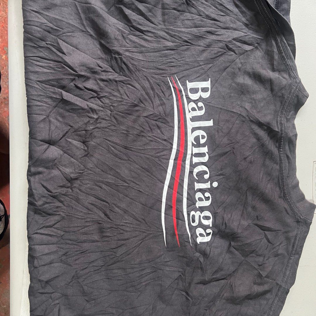Balenciaga T-shirt (Category: Tshirts & Polo Shirts ) located in Manila. Submitted by naze0729 (Listing ID 1411881585, Image 2). Description: - Balenciaga T-shirt - Color: Dark Gray - Features Balenciaga logo (front & back) - Made in Portugal - Style: Crew neck - Fabric: Slightly textured - Dimes W- 22 L- 28 - No Issue.