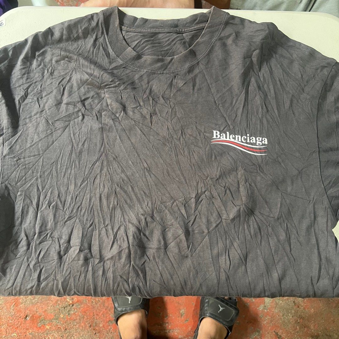 Balenciaga T-shirt (Category: Tshirts & Polo Shirts ) located in Manila. Submitted by naze0729 (Listing ID 1411881585, Image 1). Description: - Balenciaga T-shirt - Color: Dark Gray - Features Balenciaga logo (front & back) - Made in Portugal - Style: Crew neck - Fabric: Slightly textured - Dimes W- 22 L- 28 - No Issue.