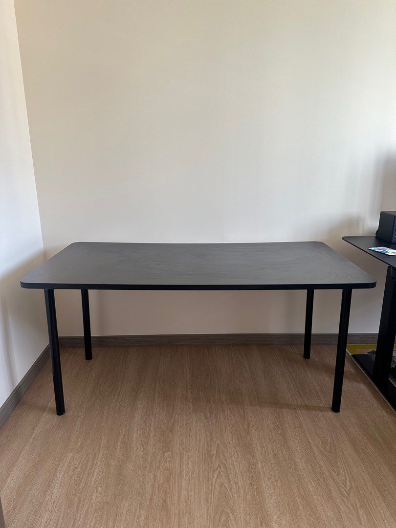 Black Rectangular Table (Category: Tables & Sets) located in Singapore. Submitted by kinbap (Listing ID 1411819912, Image 2). Description: - Stylish black rectangular table - Perfect for home office or study - Sleek design with black legs and smooth tabletop - 1.6m x 75cm x 70 cm - Ready for immediate use - Great for work or leisure.