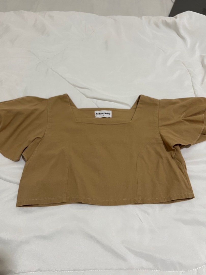 Brown cropped top (Category: Blouses) located in Quezon City. Submitted by katedeclutter (Listing ID 1411798184, Image 1). Description: - Color: Tan - Size: XS-S.