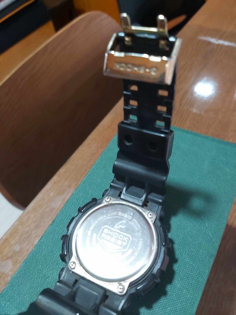 Casio G-Shock Watch (Category: Men's Watches) located in Mandaluyong City. Submitted by lelevko (Listing ID 1411856805, Image 3). Description: - Casio G-Shock watch - Black resin strap - Black and gold face - Digital display and analog hands -original and very well used - G-Shock logo on the back.