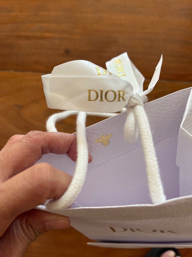 Dior Gift Bag with Ribbon (Category: Luxury Bags & Wallets) located in Las Pinas. Submitted by southofmanila (Listing ID 1411792774, Image 2). Description: - Authentic Dior gift bag - White textured exterior - Gold Dior logo - Includes white ribbon - White rope handles - Small bee emblem inside - Approximately 10cm wide x 15cm tall.