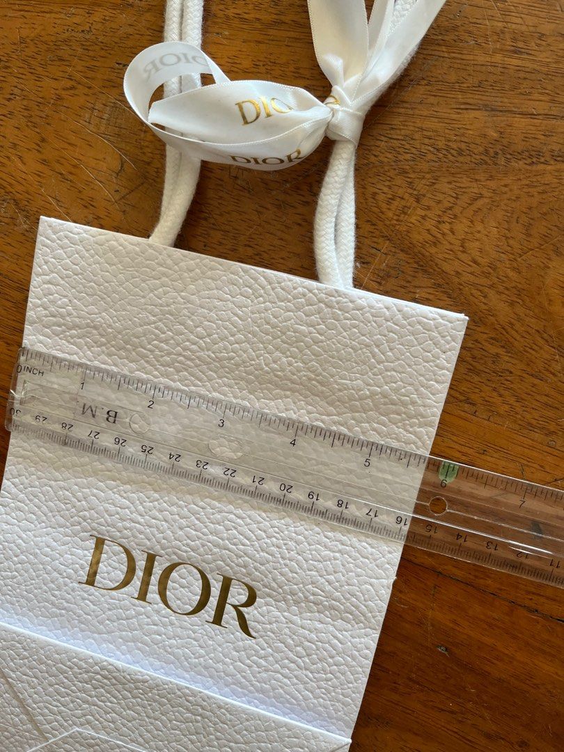 Dior Gift Bag with Ribbon (Category: Luxury Bags & Wallets) located in Las Pinas. Submitted by southofmanila (Listing ID 1411792774, Image 3). Description: - Authentic Dior gift bag - White textured exterior - Gold Dior logo - Includes white ribbon - White rope handles - Small bee emblem inside - Approximately 10cm wide x 15cm tall.