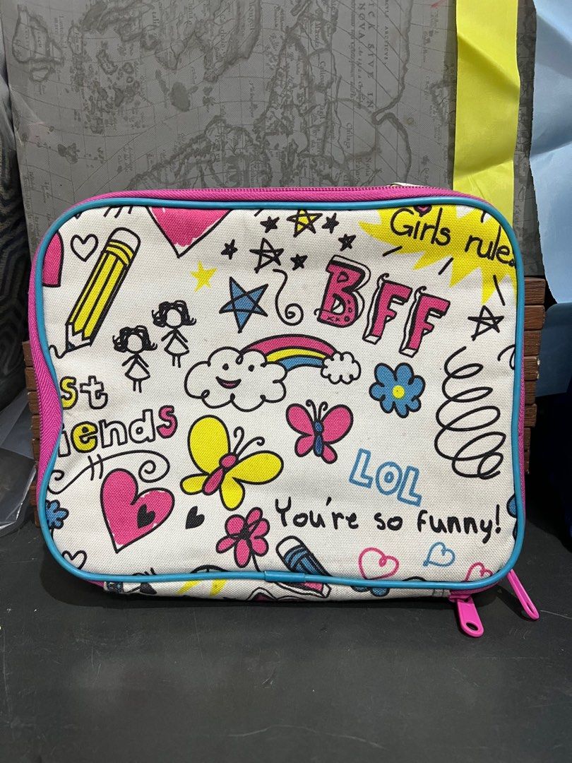 Girls' Rule Lunch Bag (Category: Babies & Kids Fashion) located in Manila. Submitted by machib (Listing ID 1411819534, Image 1). Description: - Fun and colorful lunch bag. - Features doodles and phrases like "Girls rule" and "BFF". - Pink zipper and trim with a light blue border. - Silver interior. - Great size for lunch and snacks. - Stains from storage, never used.