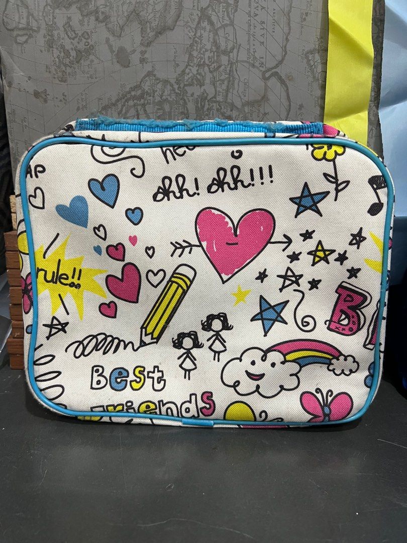 Girls' Rule Lunch Bag (Category: Babies & Kids Fashion) located in Manila. Submitted by machib (Listing ID 1411819534, Image 2). Description: - Fun and colorful lunch bag. - Features doodles and phrases like "Girls rule" and "BFF". - Pink zipper and trim with a light blue border. - Silver interior. - Great size for lunch and snacks. - Stains from storage, never used.