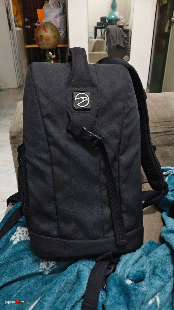 Hawk Camera Backpack (Category: Backpacks) located in Rizal. Submitted by prelovedthreadsss (Listing ID 1411831535, Image 1). Description: - Black Hama camera backpack - Multiple compartments for camera gear - Padded dividers inside - Zippered top compartment - Side mesh pocket - Padded straps for comfort - Made with Durashield fabrics.