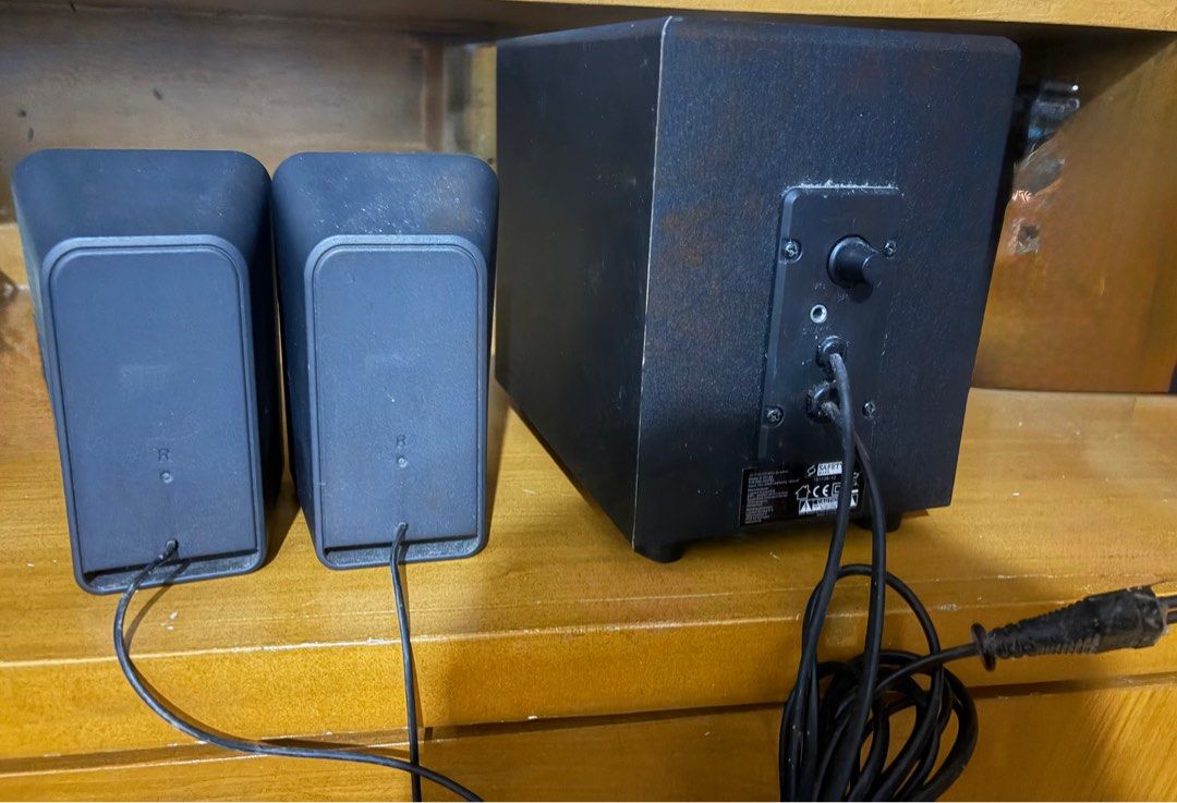 Logitech Z213 Compact Speaker System with Subwoofer (Category: Soundbars, Speakers & Amplifiers) located in Dasmarinas. Submitted by hopefullyyoursph (Listing ID 1411879171, Image 2). Description: Logitech speaker system with a subwoofer. - Includes two satellite speakers and a subwoofer unit. - has volume control knob and various input/output ports. - has a rear-facing port and a bottom-facing speaker - wired / jack - Color: Black - Brand: Logit