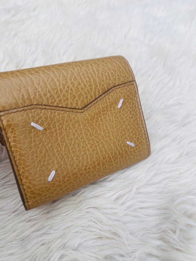 Maison Margiela Leather Wallet (Category: Luxury Bags & Wallets) located in Cavite. Submitted by authenticfindsbyging (Listing ID 1411894685, Image 2). Description: - Maison Margiela wallet - Unique flap closure - Multiple compartments - Zippered section - Card slots - Textured leather - Maison Margiela logo inside .