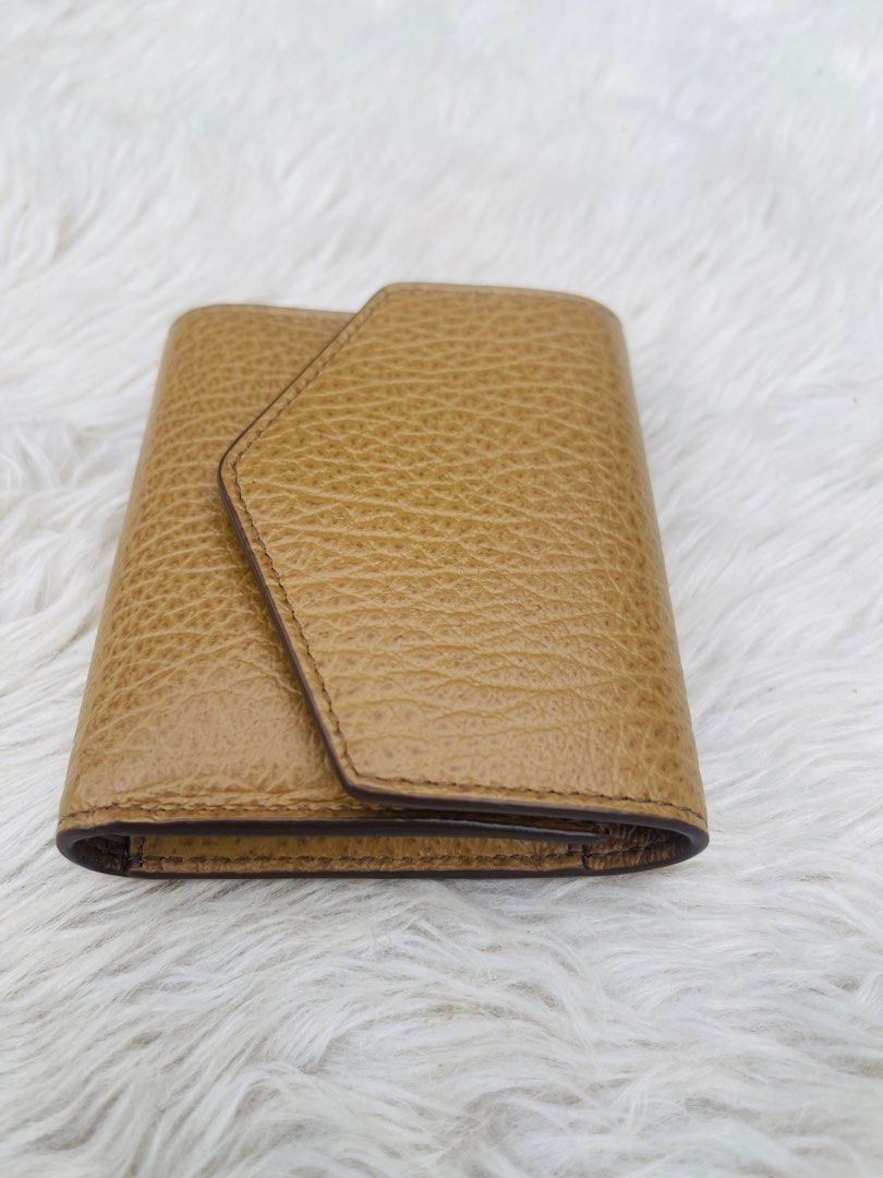 Maison Margiela Leather Wallet (Category: Luxury Bags & Wallets) located in Cavite. Submitted by authenticfindsbyging (Listing ID 1411894685, Image 3). Description: - Maison Margiela wallet - Unique flap closure - Multiple compartments - Zippered section - Card slots - Textured leather - Maison Margiela logo inside .