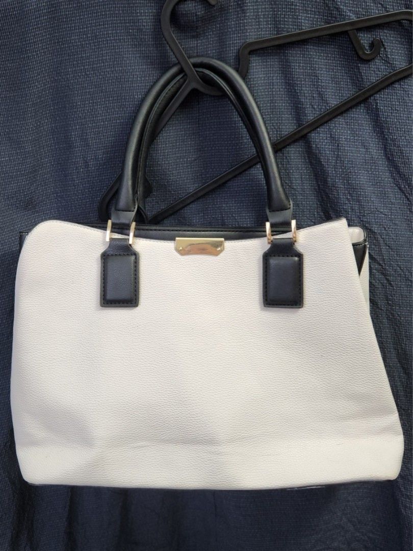 Multi-Compartment Office Work Bag (Category: Luxury Bags & Wallets) located in Makati City. Submitted by zenearth73f57 (Listing ID 1411869153, Image 1). Description: Spacious handbag with soft leather look & feel. With 3 big compartments and 2 smaller pockets inside. The zippered compartment fits 13" macbook air. Handles are still intact. Clean interiors. Minimal but normal signs of usage on the gold hardware. Selling low due to: - color transfer