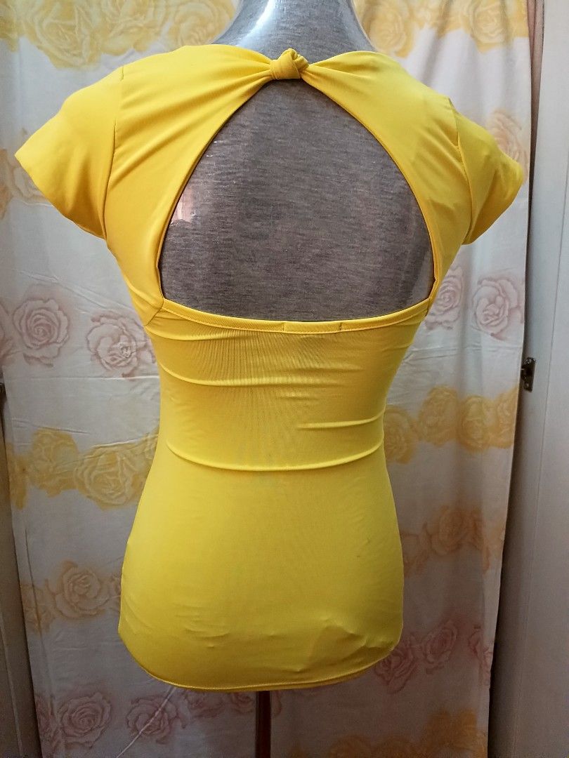 Original Seductions Yellow Fitted Open-Back Top XS (Like New) (Category: Blouses) located in Kawit. Submitted by blendz1968 (Listing ID 1408948362, Image 2). Description: Original Seductions Yellow Fitted Top with Bow Detail Brand: Seductions (mid-range, mall brand) Condition: Like new Size: XS (can move slower than M/L, but attracts fitted-top buyers) Color: Vibrant yellow Fabric: Stretchable with comfortable wear (88% Polyester / 12% Spandex) D