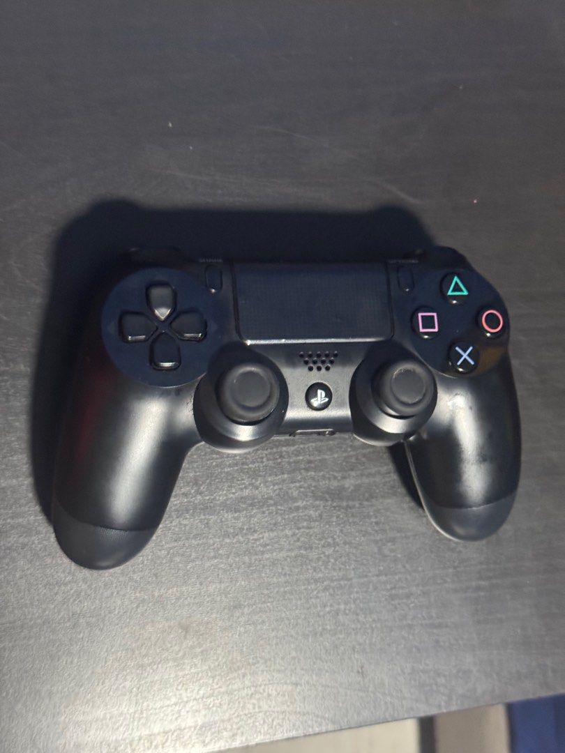 PS4 controller (Category: PlayStation) located in Singapore. Submitted by footballis_life (Listing ID 1411898945, Image 1). Description: No scratches or dents .