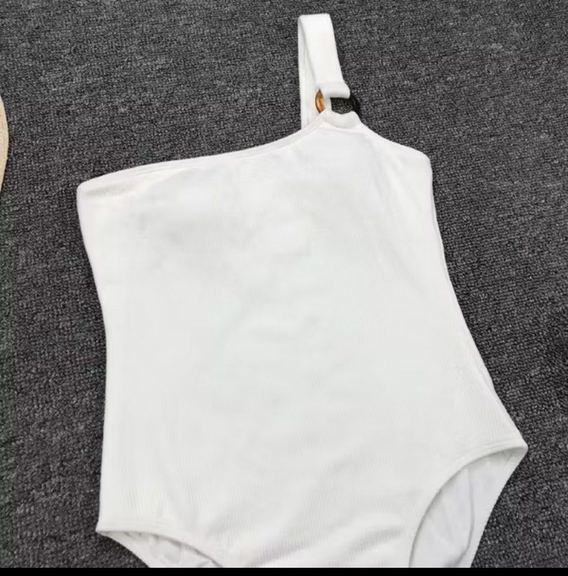 White One-Shoulder Swimsuit (Category: Bikinis & Swimsuits) located in Imus. Submitted by declutterwithria (Listing ID 1411876667, Image 3). Description: - White one-shoulder swimsuit - Unique ring detail on strap - Textured fabric - Flattering cut - Stylish and comfortable - Ideal for beach or poolside READ BEFORE INQUIRING! -Most items are preloved unless stated otherwise. -First to pay gets the item‼️ -Shipping day is every Friday only‼️ 📌 ST