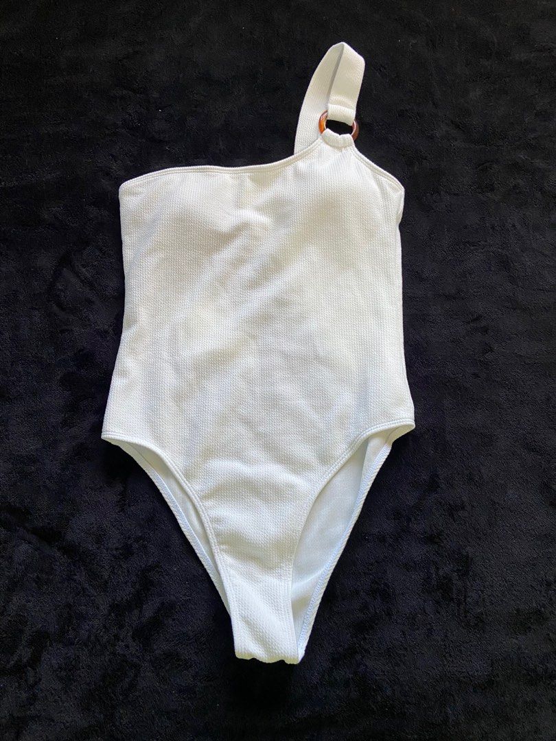 White One-Shoulder Swimsuit (Category: Bikinis & Swimsuits) located in Imus. Submitted by declutterwithria (Listing ID 1411876667, Image 1). Description: - White one-shoulder swimsuit - Unique ring detail on strap - Textured fabric - Flattering cut - Stylish and comfortable - Ideal for beach or poolside READ BEFORE INQUIRING! -Most items are preloved unless stated otherwise. -First to pay gets the item‼️ -Shipping day is every Friday only‼️ 📌 ST