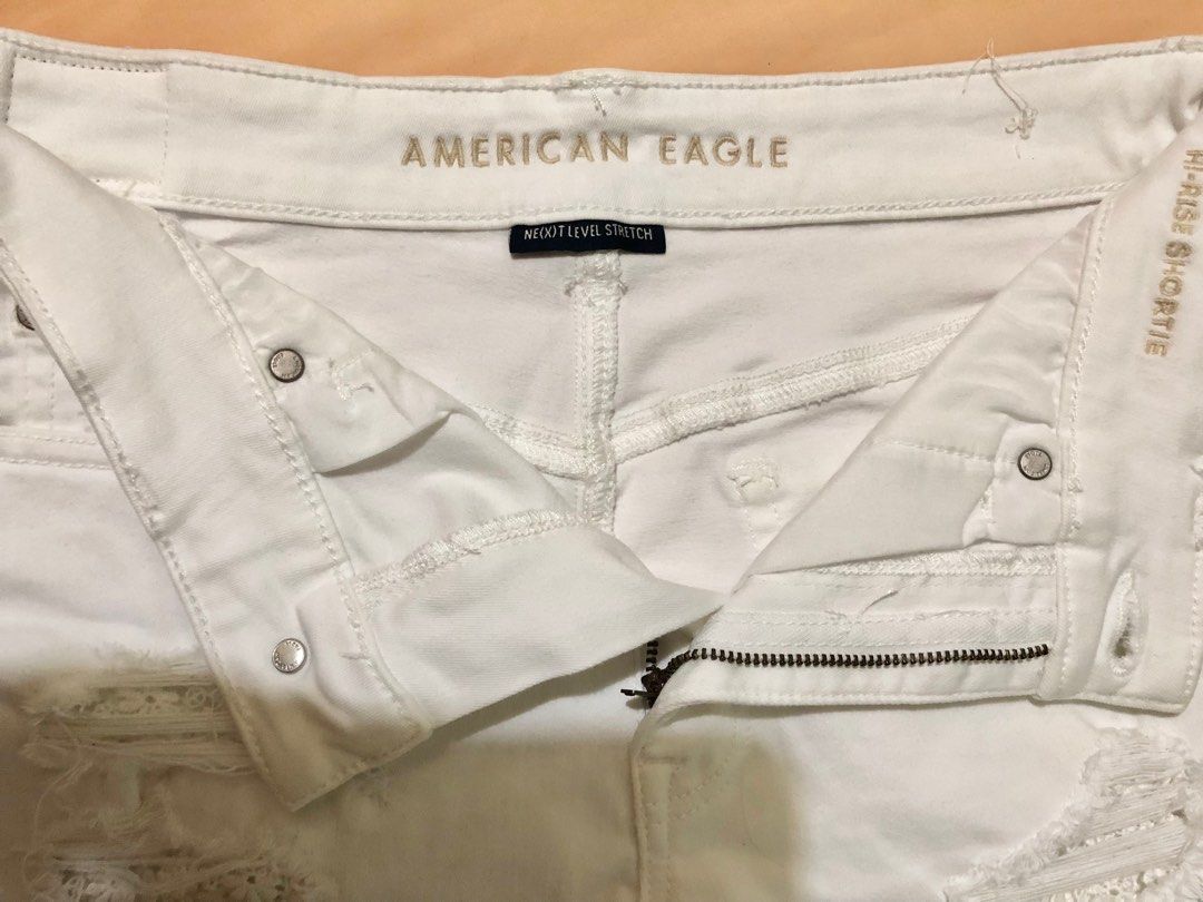 American Eagle Hi-Rise Shortie (Category: Shorts) located in Luna. Submitted by esorale (Listing ID 1412110017, Image 2). Description: White denim shorts from American Eagle. Features a high-rise waist and distressed detailing. Includes a zipper and button closure. ✅ Never been used ✅ Shipping fee will be shouldered by the buyer. ✅ Waistline: 27-28" ✅ MOP: Gcash/Bank transfer ✅ Can ship nationwide via flash express.