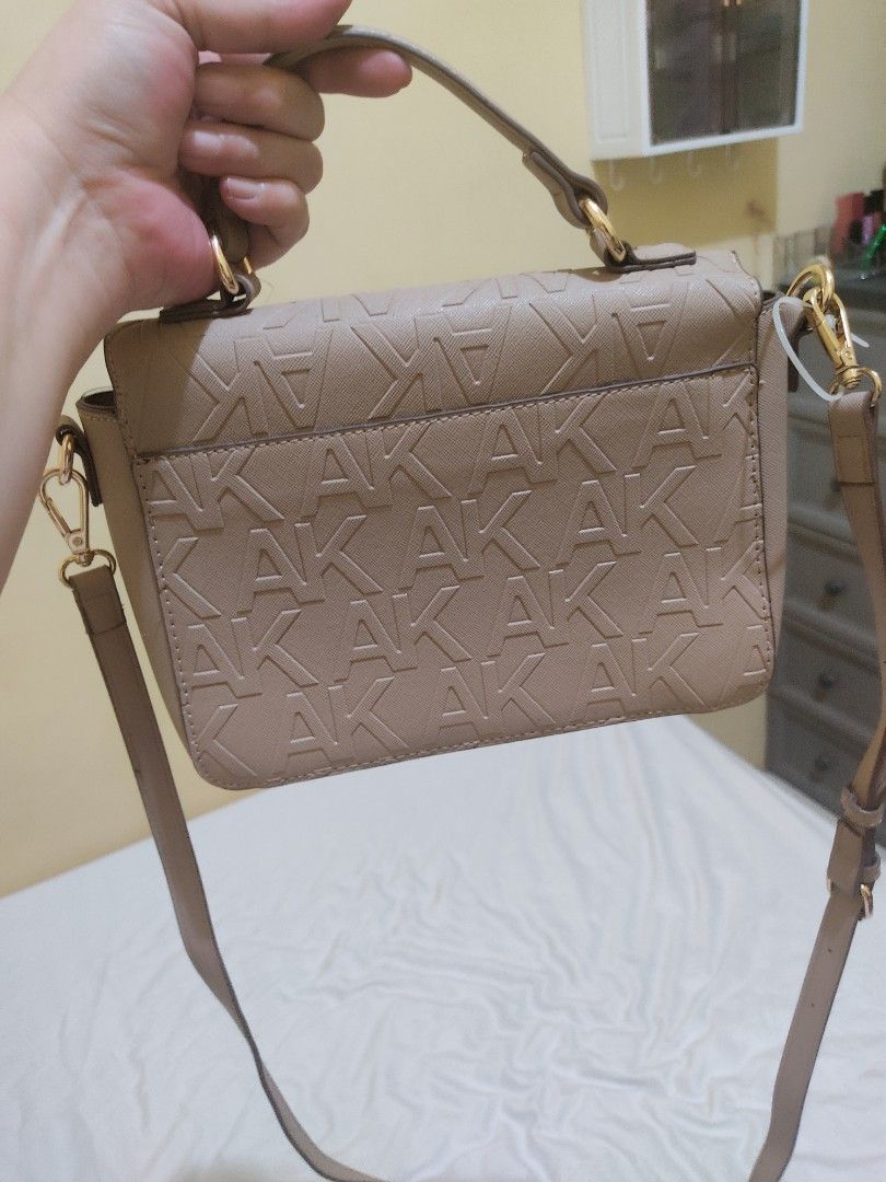 Anne Klein Embossed Logo Crossbody Bag (Category: Cross-body Bags) located in Cavite. Submitted by perfectfinds (Listing ID 1412113526, Image 2). Description: - Anne Klein crossbody bag - Neutral beige color - Embossed logo design - Top handle and chain swag - Main compartment with multiple pockets - Detachable strap for versatile carrying Bought for my self for approximately 2,500. never used it. .